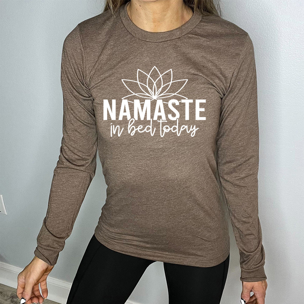 Heather brown long sleeve shirt with the words "Namaste in bed today" with a line art of a lotus flower above it