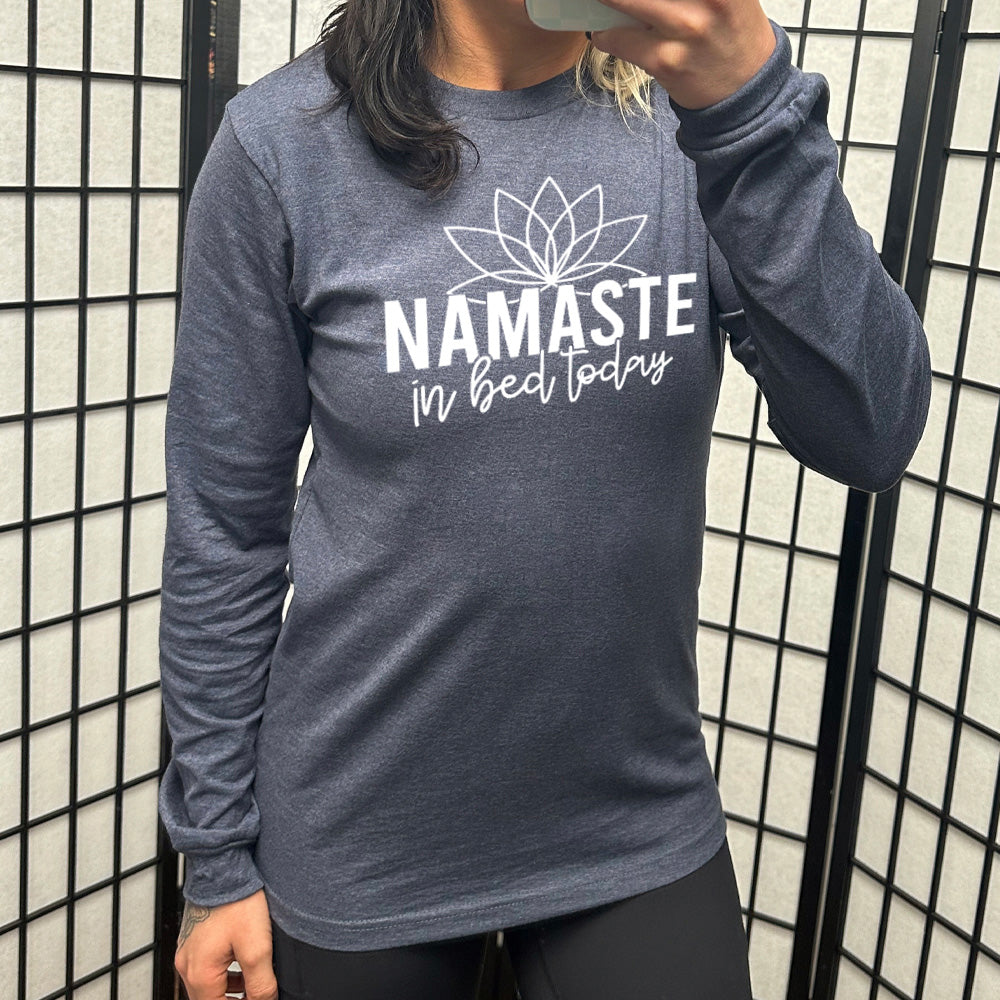 Heather navy long sleeve shirt with the words "Namaste in bed today" with a line art of a lotus flower above it