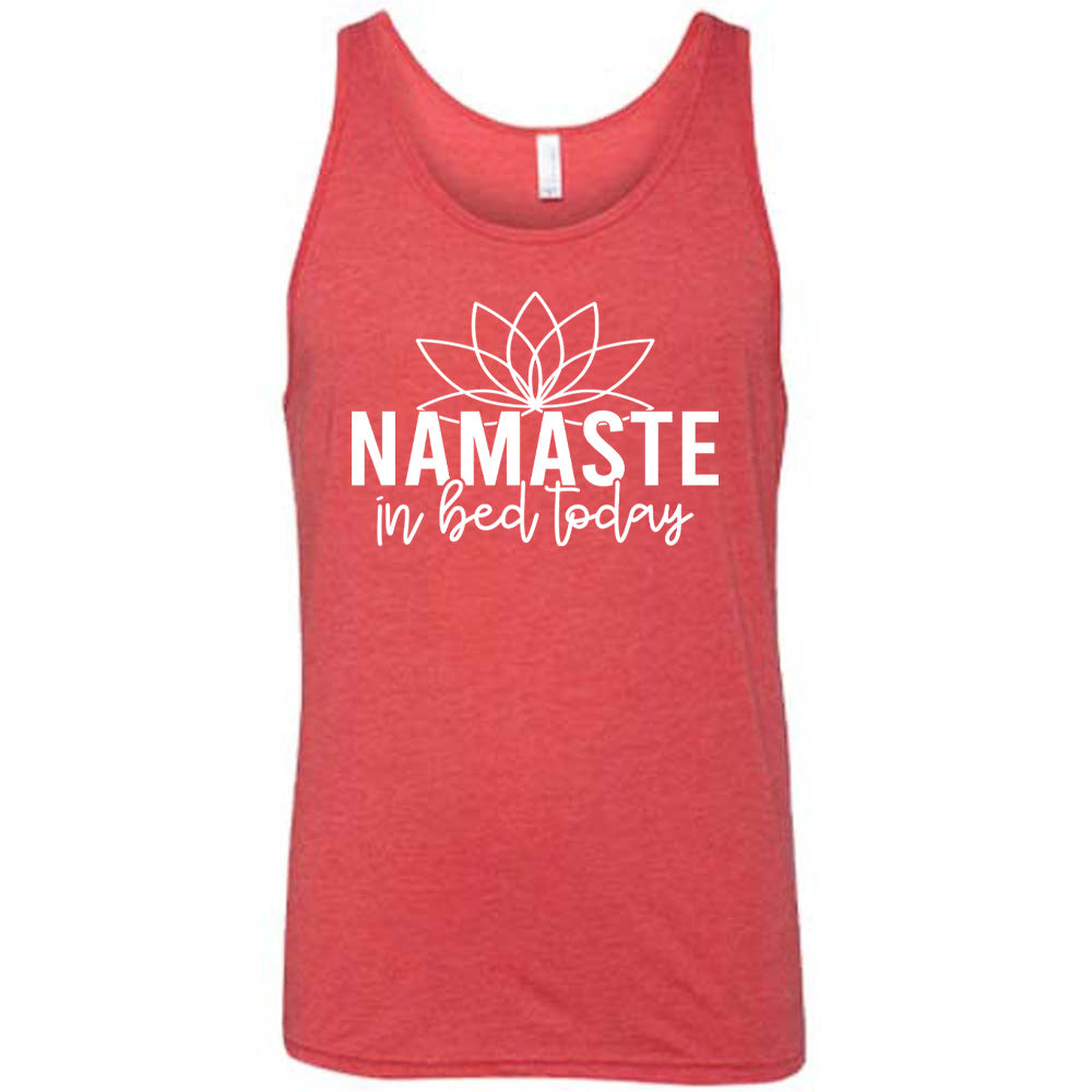 Red unisex tank with the words "Namaste in bed today" with a line art of a lotus flower above it