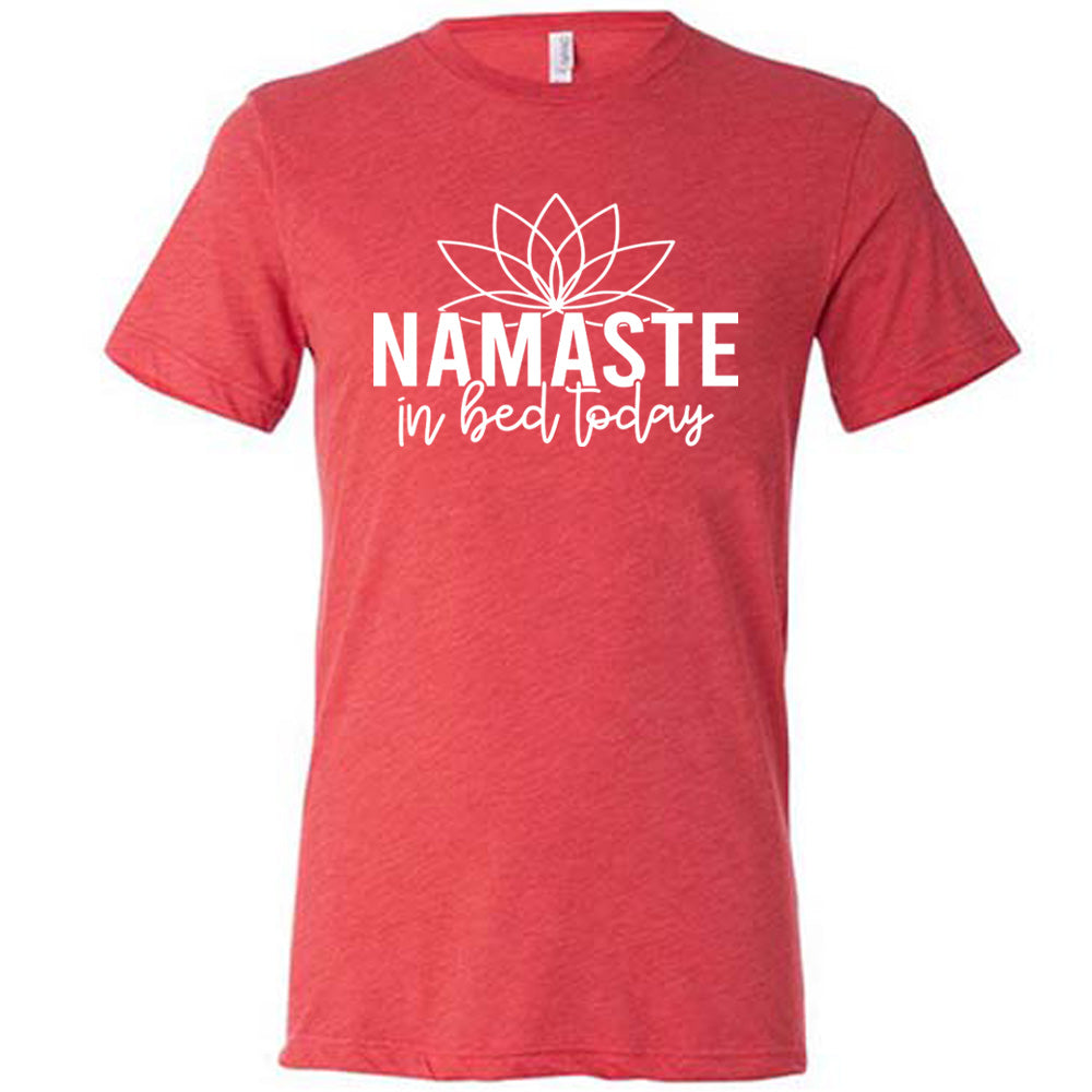 Red unisex tee with the words "Namaste in bed today" with a line art of a lotus flower above it