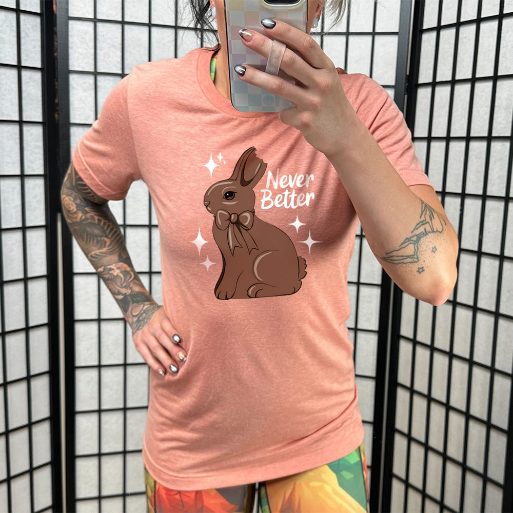 Sunset colored shirt with a chocolate bunny graphic on it that says "Never Better"