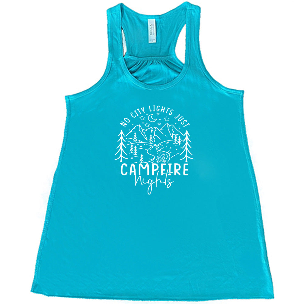 Teal colored flowy tank with a stars and mountain graphic on it that says "No City Lights Just Campfire Nights"