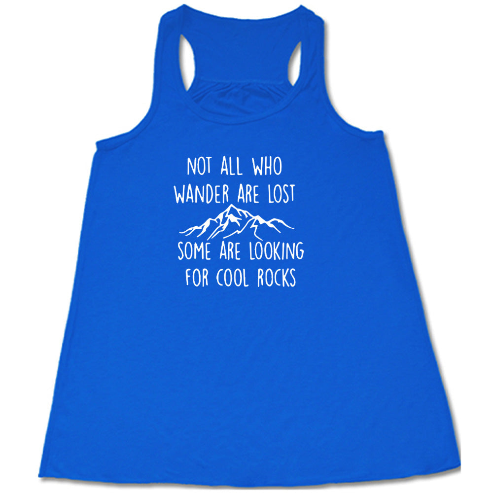 Blue colored flowy tank with a mountain graphic on it that says "Not All Who Wander Are Lost Some Are Looking For Cool Rocks"