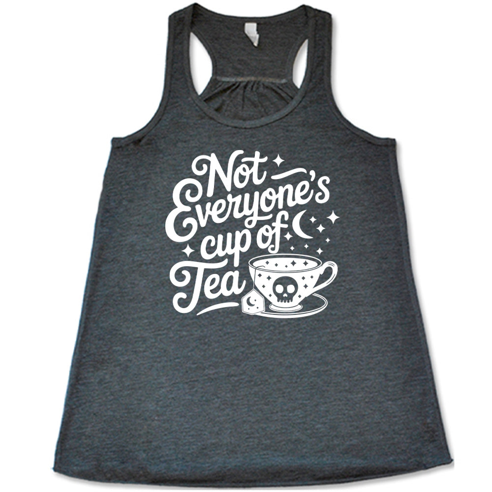 grey flowy tank with the words "not everyone's cup of a tea" in a cursive font, with the graphics of a moon and little stars, and a tea cup with a skull on it with stars and the tea bag has a moon on it