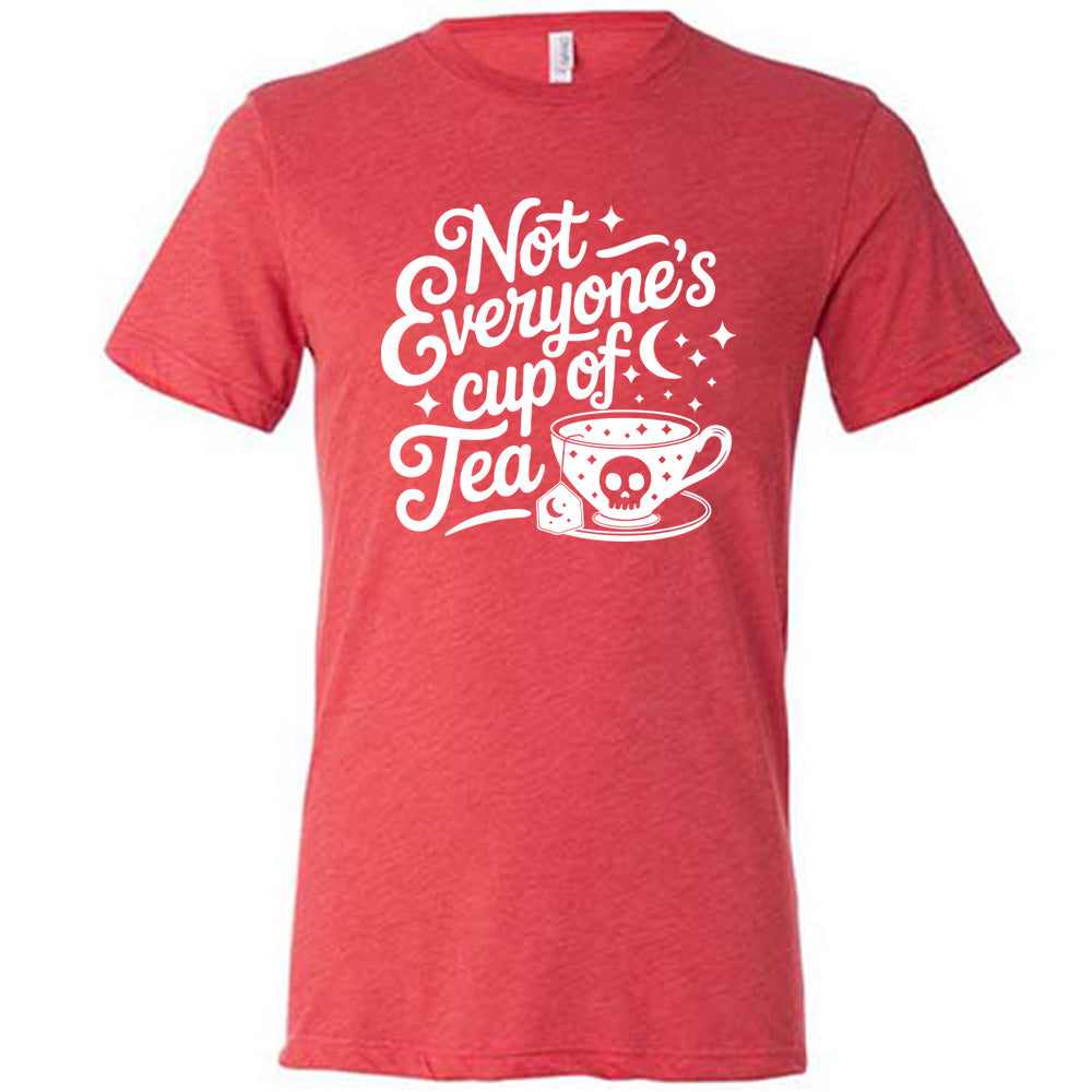 red unisex tee with the words "not everyone's cup of a tea" in a cursive font, with the graphics of a moon and little stars, and a tea cup with a skull on it with stars and the tea bag has a moon on it