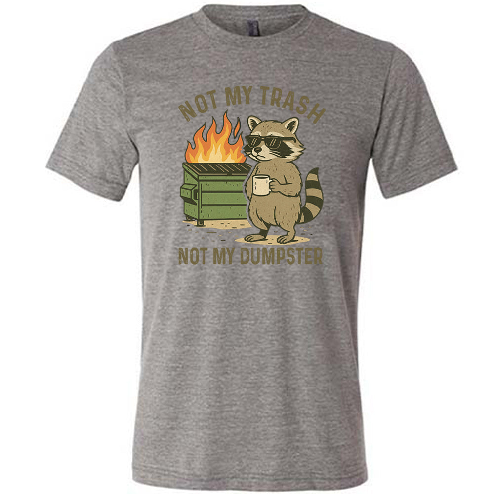 Grey Unisex Tee, with wording Not My Trash Not My Dumpster, image of racoon with sunglasses and coffee as well as a dumpster that is on fire