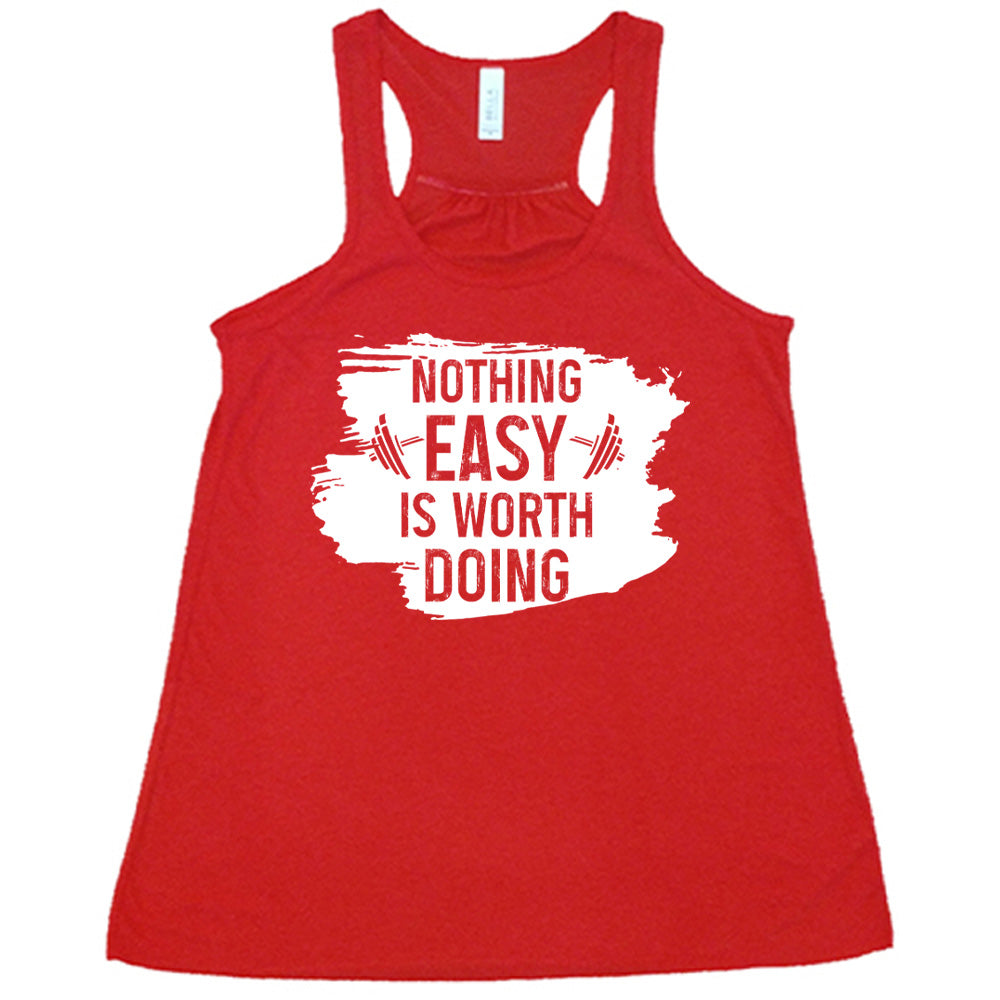 Red Flowy Tank, with wording Nothing Easy is Worth Doing, lettering is color of shirt with barbells all over a white patch