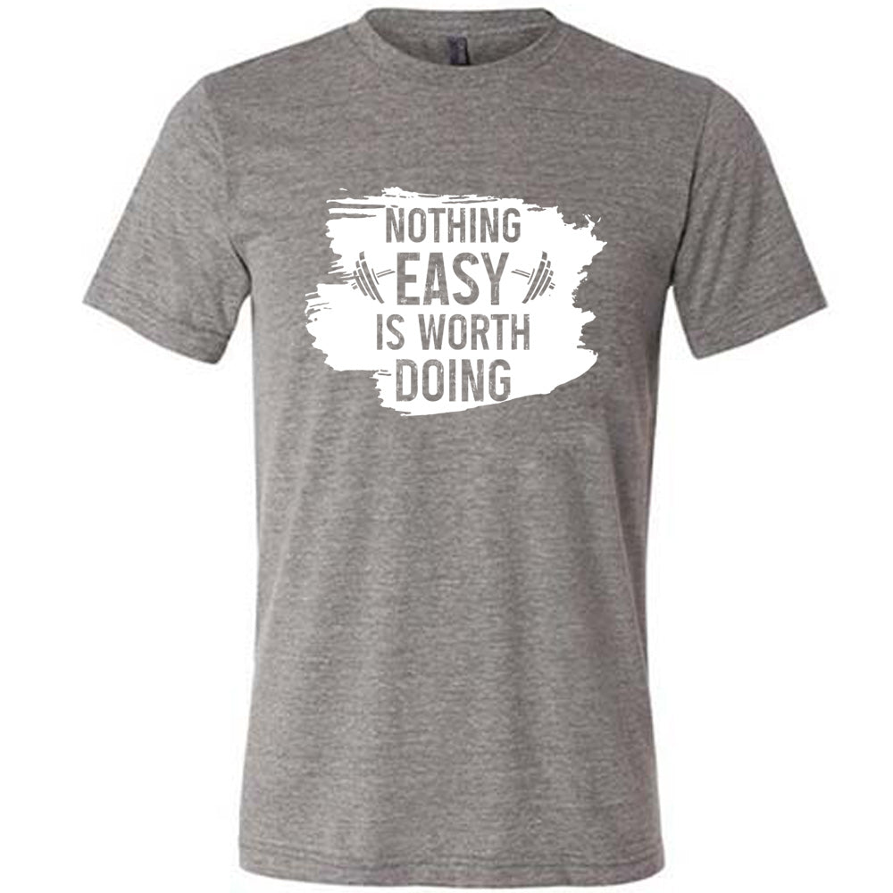 Grey Unisex Tee, with wording Nothing Easy is Worth Doing, lettering is color of shirt with barbells all over a white patch