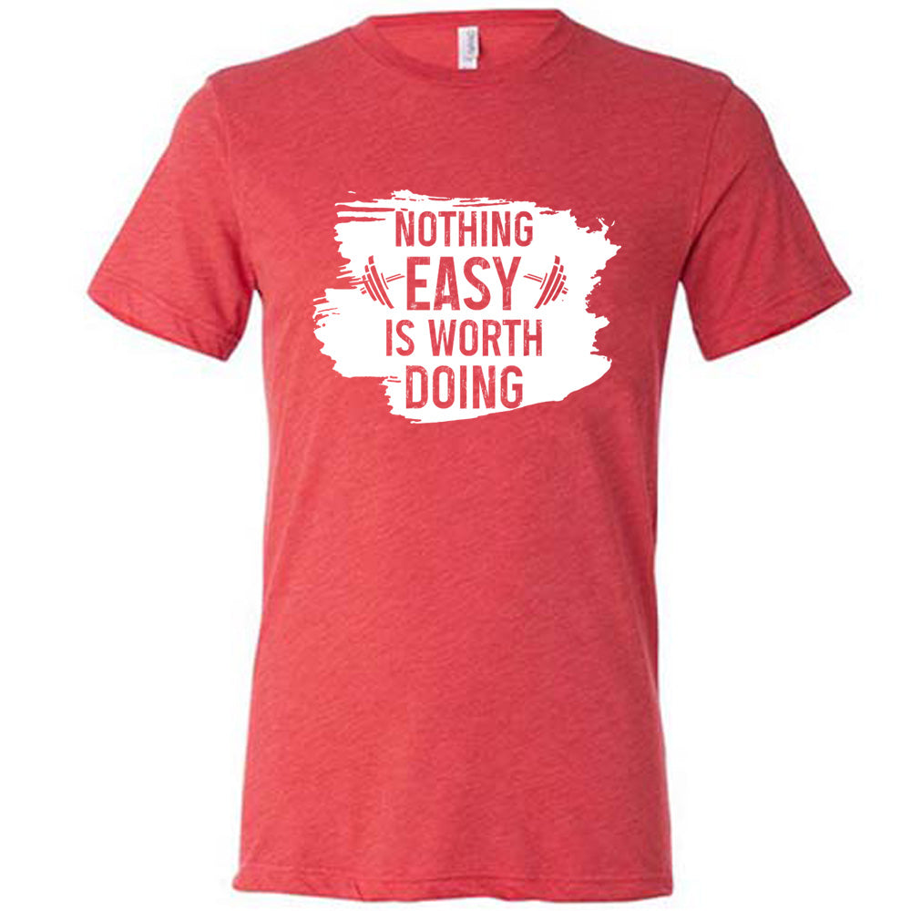 Red Unisex Tee, with wording Nothing Easy is Worth Doing, lettering is color of shirt with barbells all over a white patch