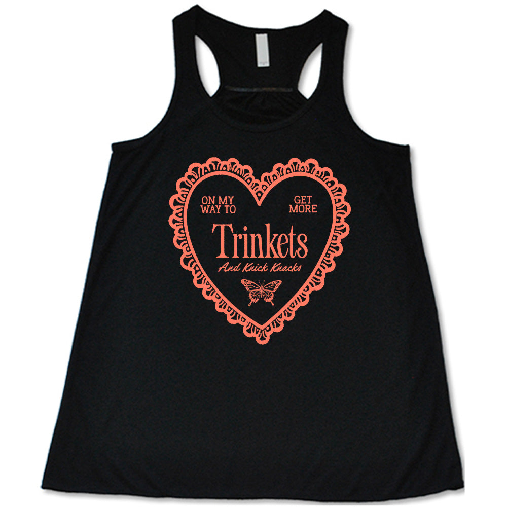 black flowy tank with the graphic of a large heart with a lacy border, and within it the words "on my way to get more trinkets and Knick Knacks" and the graphic of a little butterfly