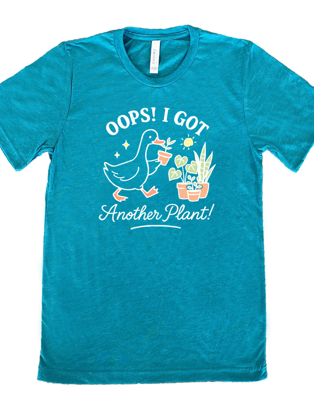 teal unisex tee with the graphic of a goose holding a little plant, walking toward a few other plants, and the words surrounding it saying "Oops! I got another plant!"