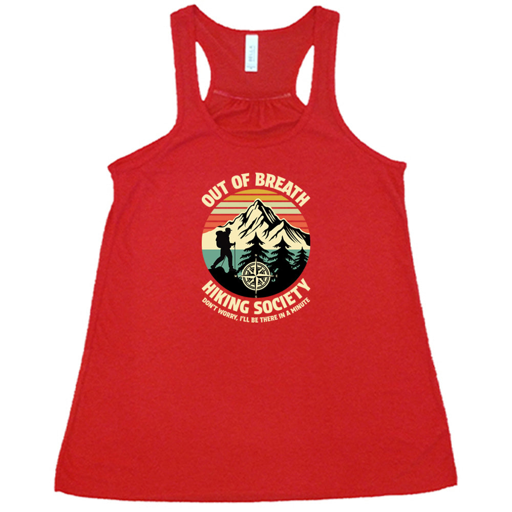 Red colored flowy tank with a Hiker and mountain graphic on it that says "Out Of Breath Hiking Society"