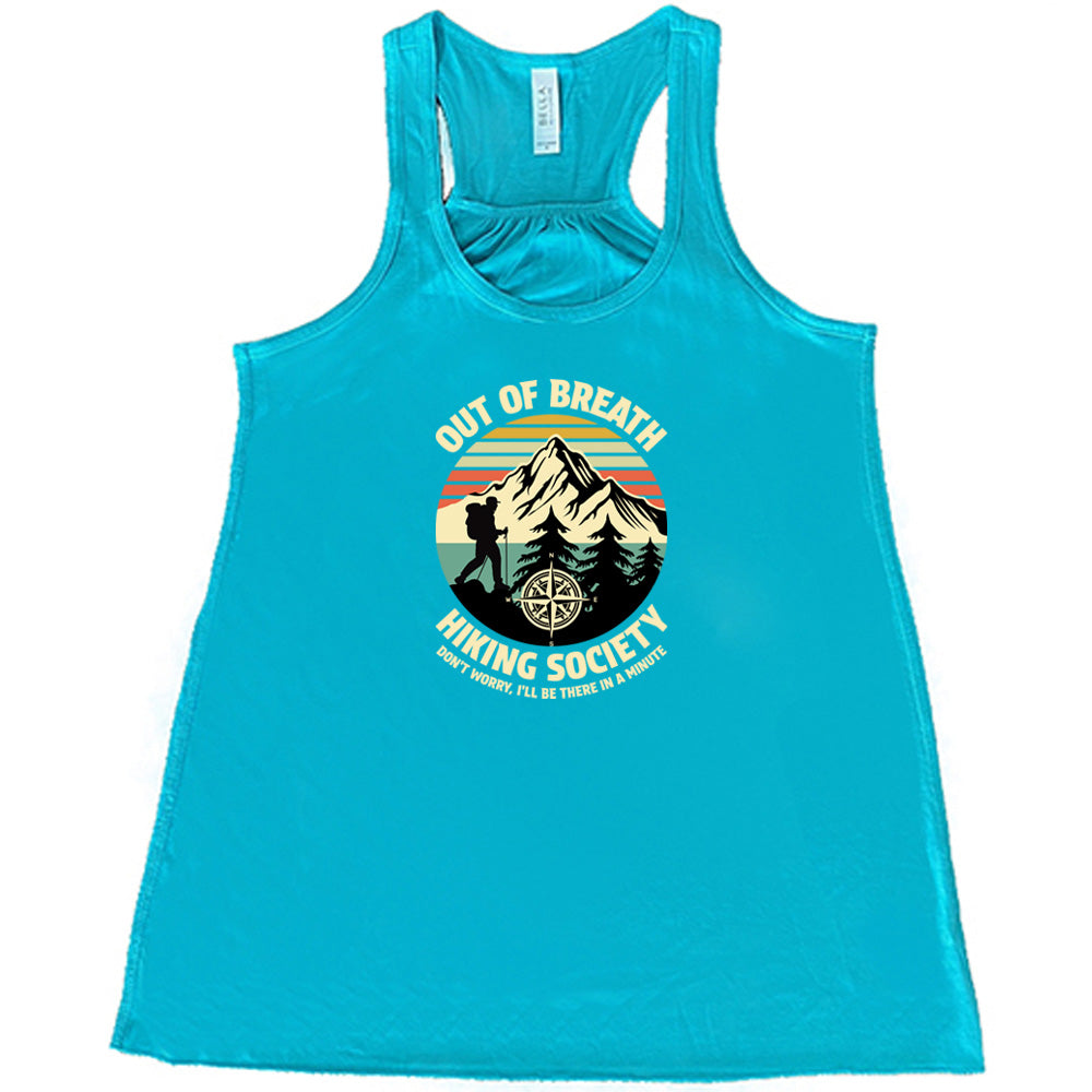 Teal colored flowy tank with a Hiker and mountain graphic on it that says "Out Of Breath Hiking Society"