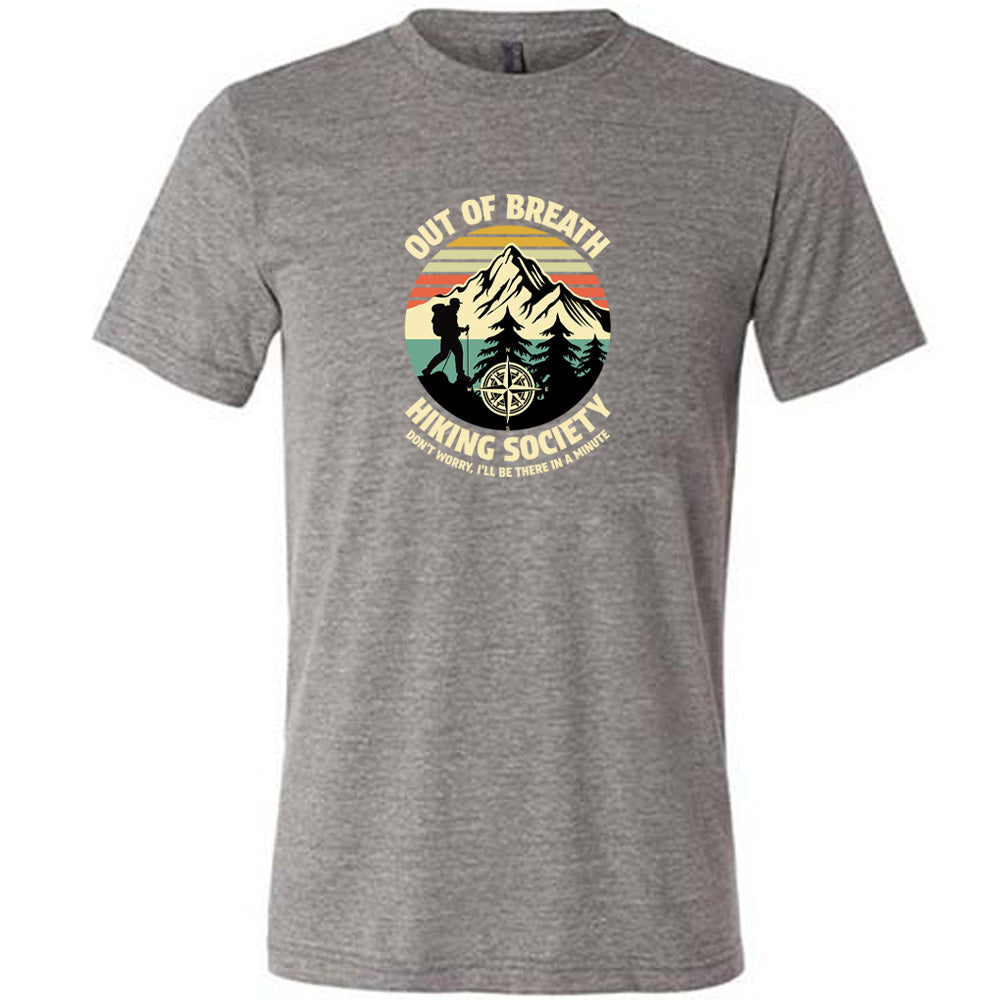 Grey colored shirt with a hiker and mountain graphic on it that says "Out Of Breath Hiking Society"