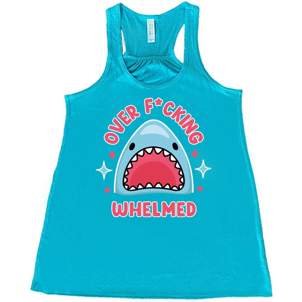 teal racerback flowy tank with the graphic of a shark's head with mouth wide open, and the words around the graphic saying "over f*cking whelmed" and a few stars on the sides