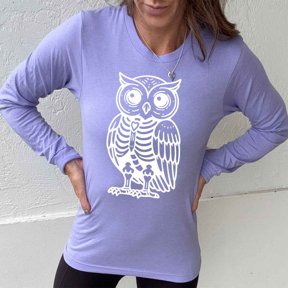 heather dark lavender long sleeve tee with the large graphic of an owl with part of its body in skeletal form, with a little heart in the middle of its ribcage