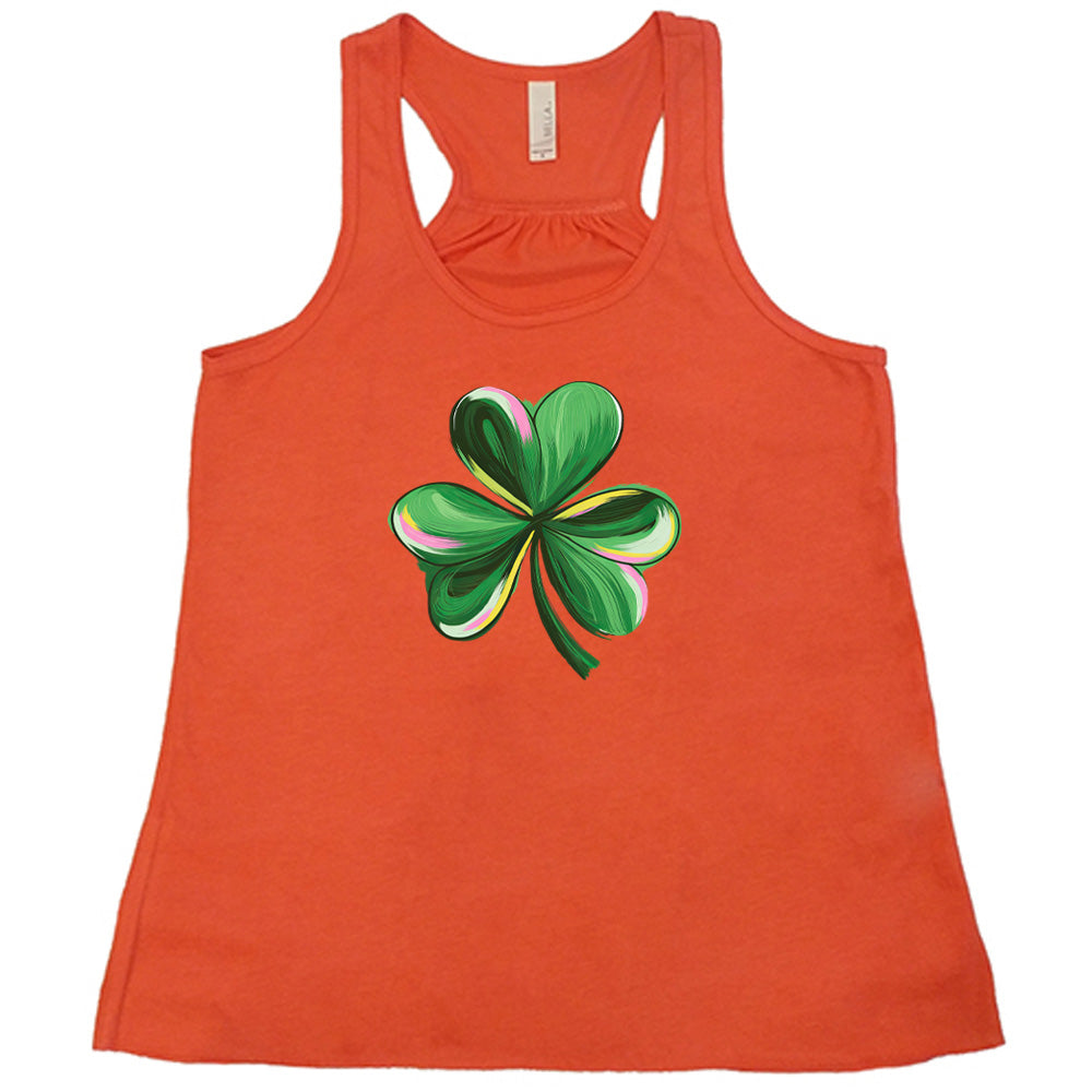 coral shirt with a painted shamrock graphic on it