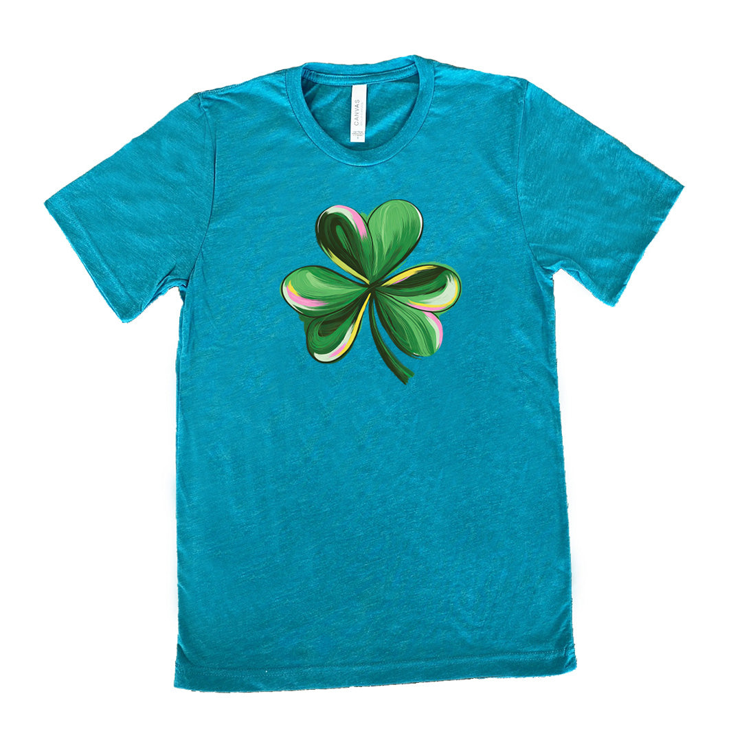 teal shirt with a painted shamrock graphic on it
