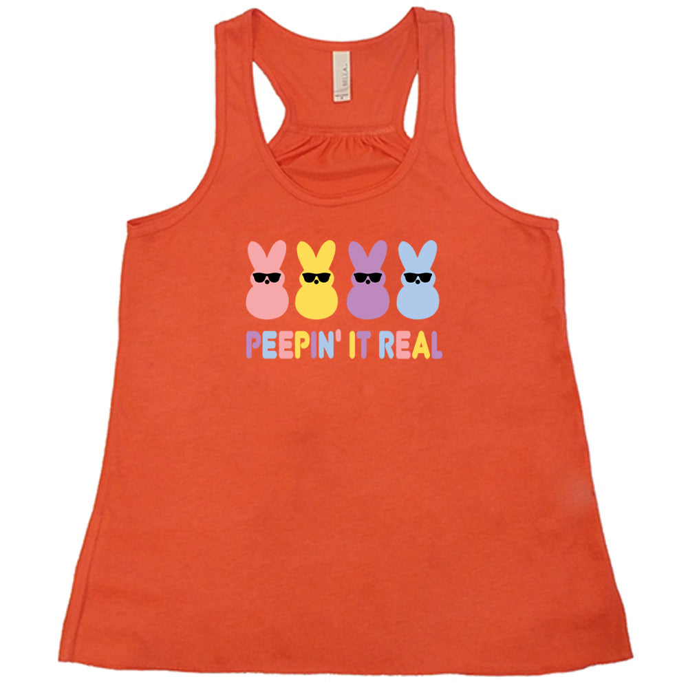 Coral colored flowy tank with an Easter-colored bunnies graphic on it that says "Peepin it Real"