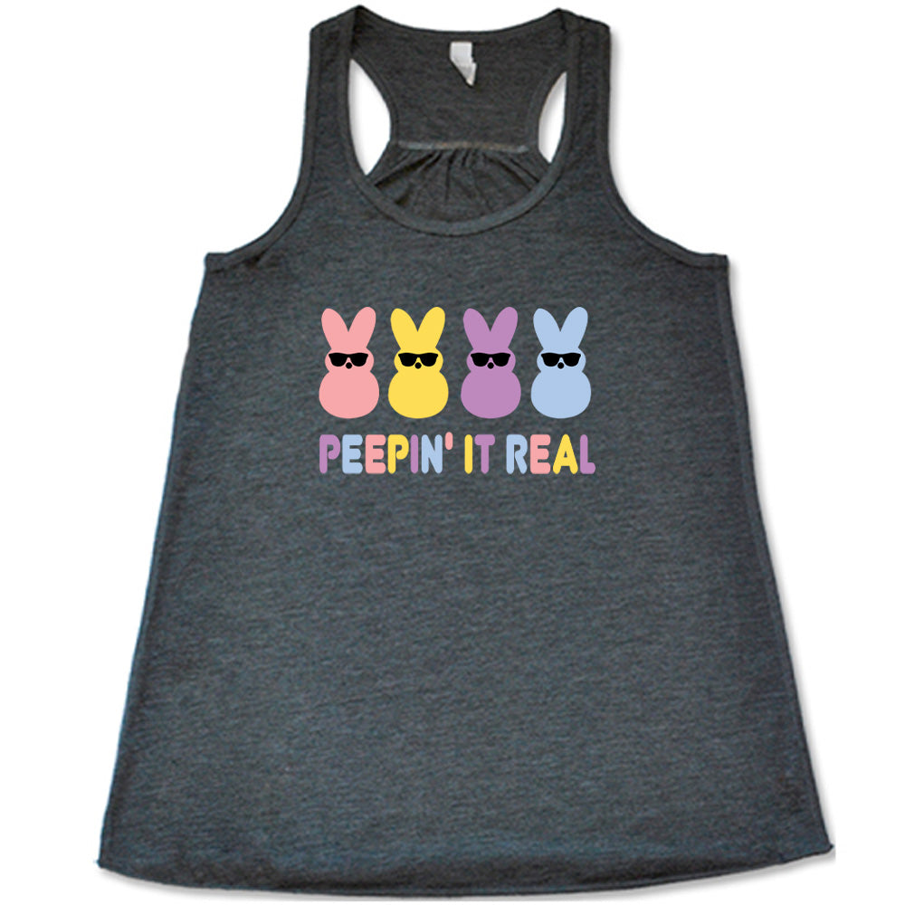 Grey colored flowy tank with an Easter-colored bunnies graphic on it that says "Peepin it Real"