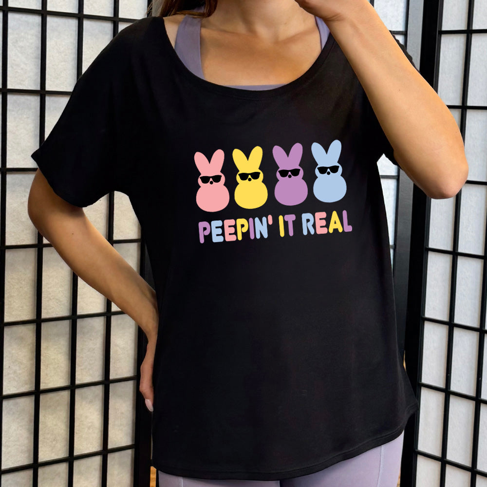 Black colored shirt with an Easter-colored bunnies graphic on it that says "Peepin it Real"