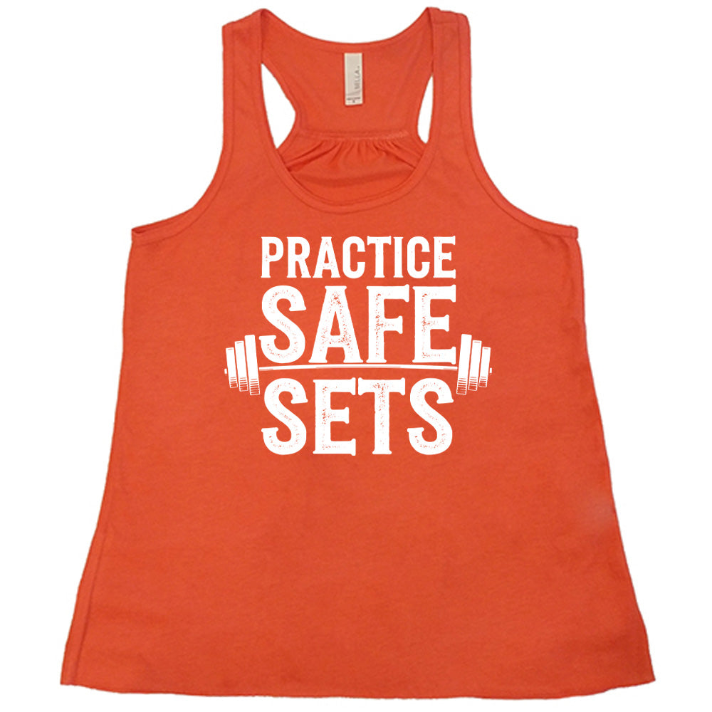 coral flowy tanks with the words "practice safe sets" on it, with the image of a barbell