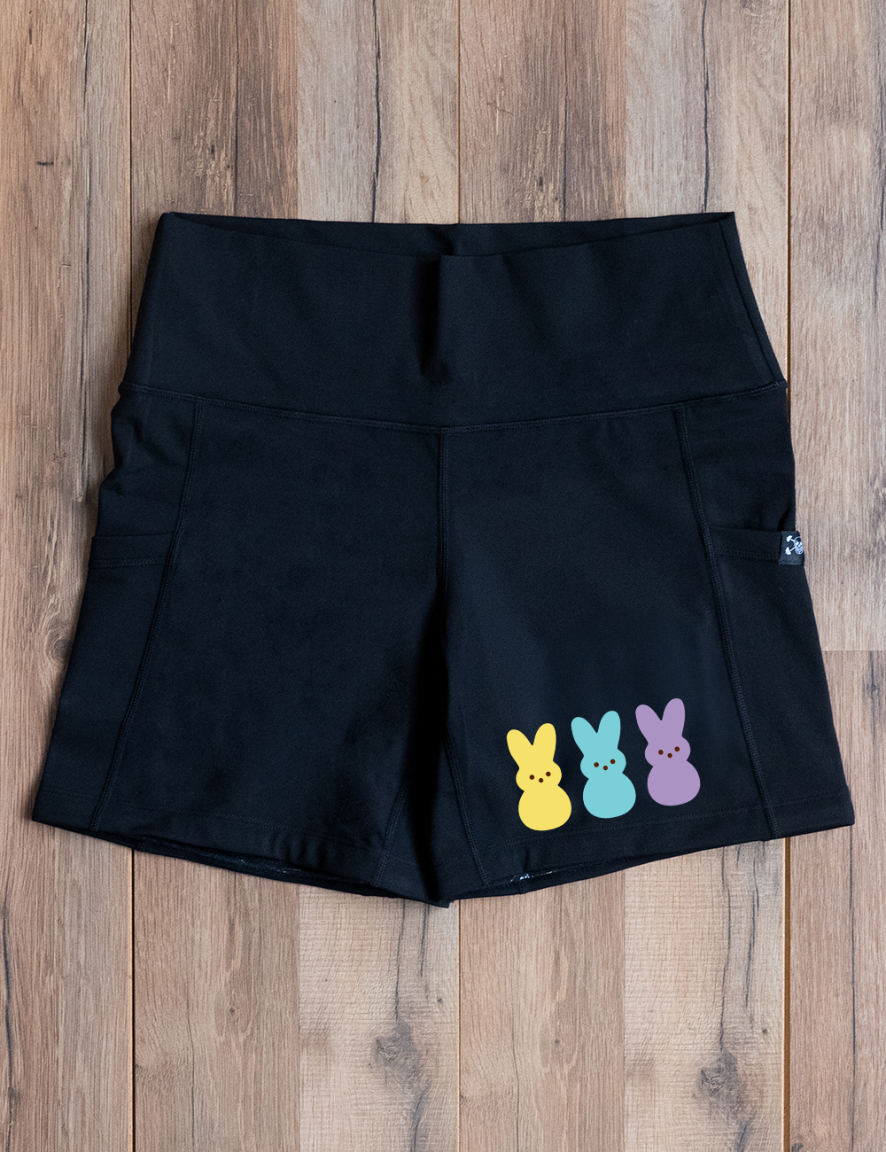 black 5" shorts with a yellow, blue, and purple colored peeps on the right side