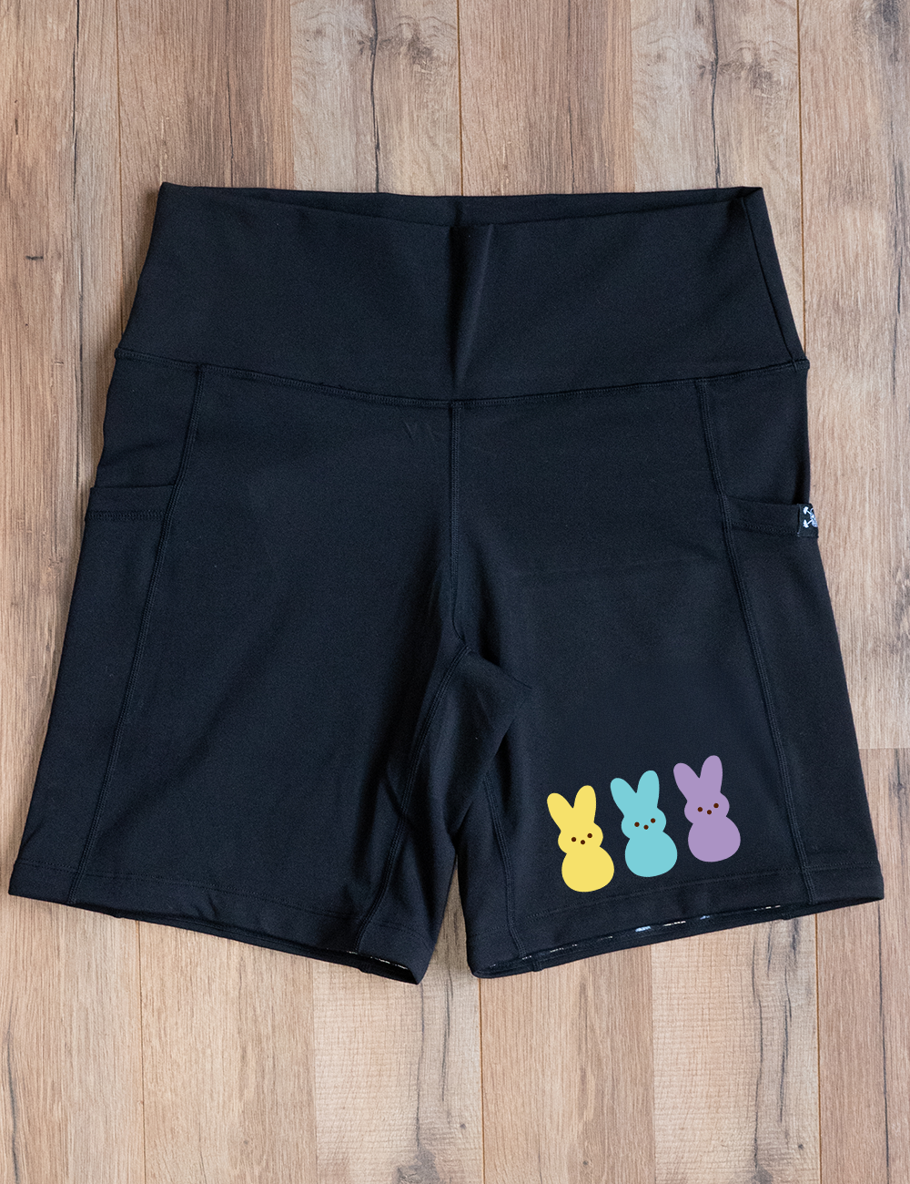 black 7" shorts with a yellow, blue, and purple colored peeps on the right side