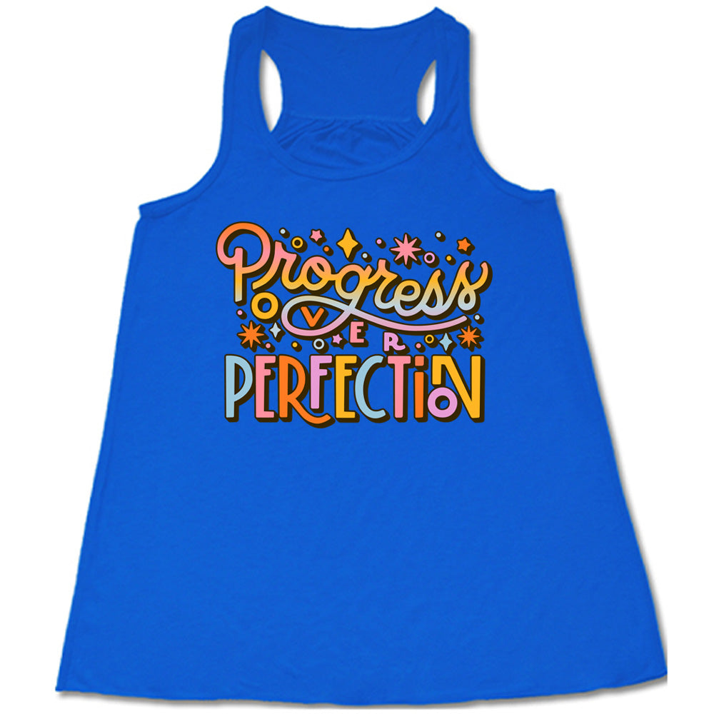 Blue flowy tank with Progress Over Perfection written in colorful lettering, with various stars
