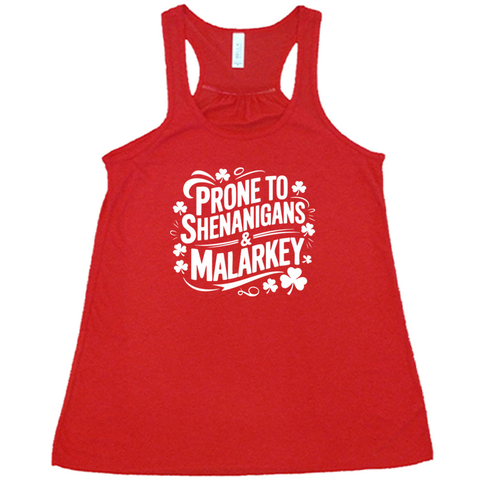 red shirt with the quote "Prone To Shenanigans & Malarkey" on it