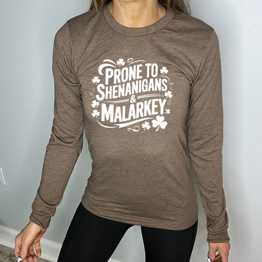 heather brown long sleeve with the words "prone to shenanigans & malarkey" surrounded by clovers