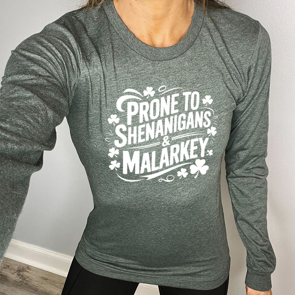 heather forest long sleeve with the words "prone to shenanigans & malarkey" surrounded by clovers
