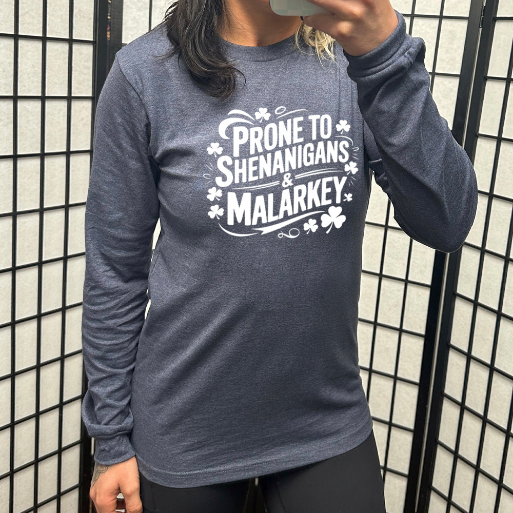 heather navy long sleeve with the words "prone to shenanigans & malarkey" surrounded by clovers
