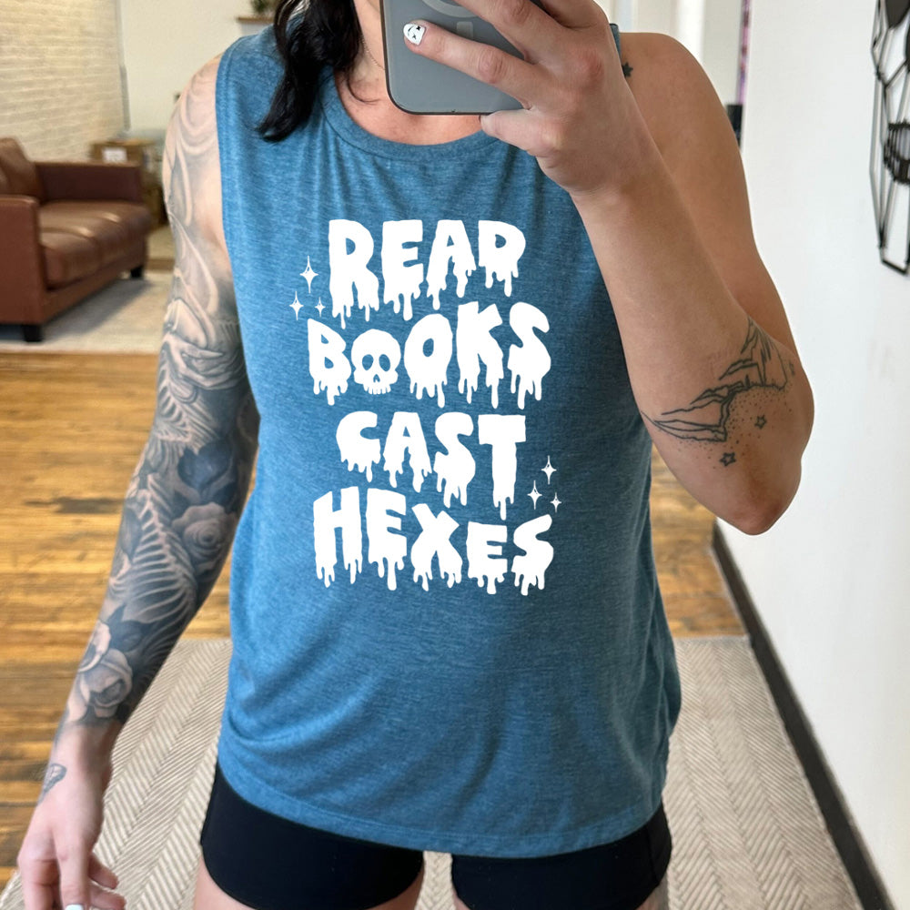 deep teal muscle tank with the horror-style text saying "Read Books Cast Hexes" on it, with one of the "o"s being a skull, with a few little stars