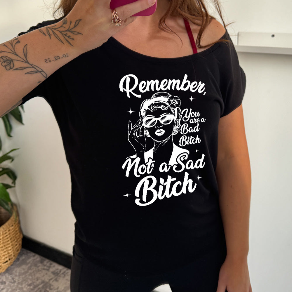 Black slouchy tee with the words "Remember, you are a bad bitch not a sad bitch" with the graphic of a vintage-looking woman adjusting her sunglasses