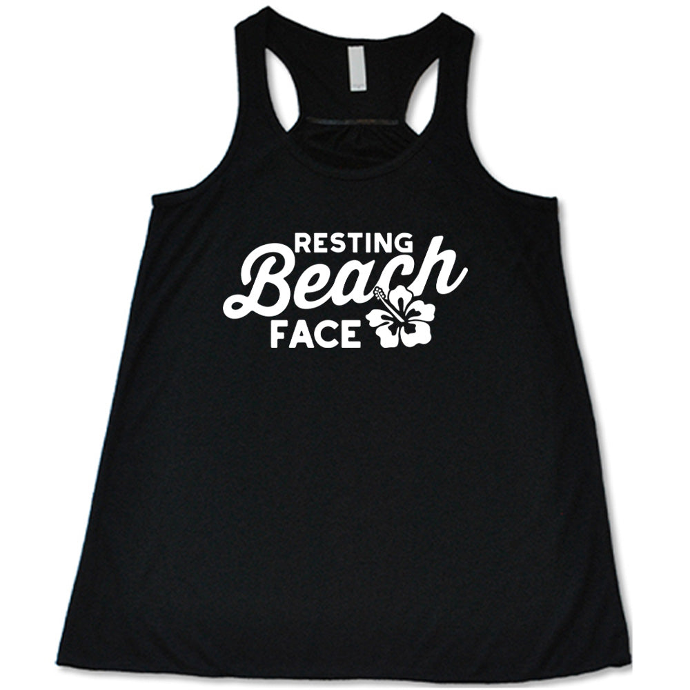 Black colored flowy tank with a flower graphic on it that says "Resting Beach Face"