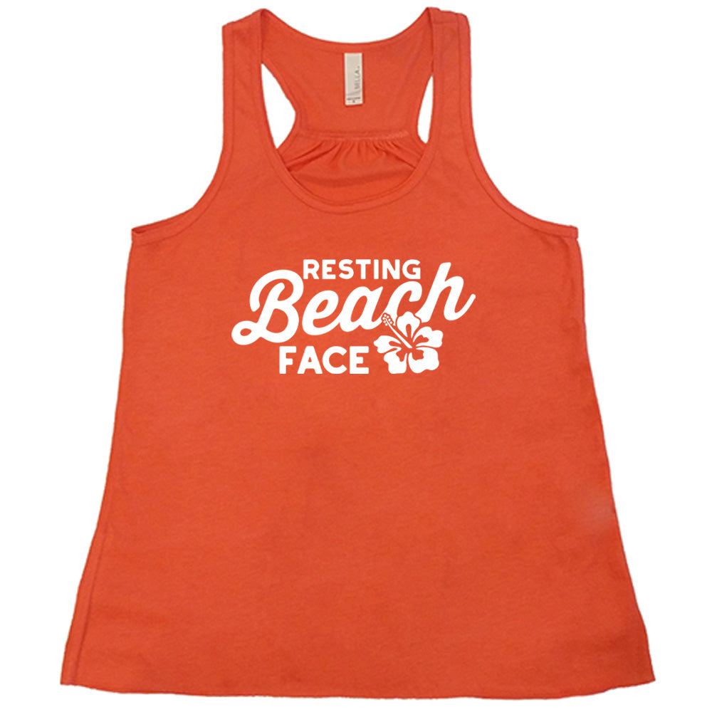 Coral colored flowy tank with a flower graphic on it that says "Resting Beach Face"