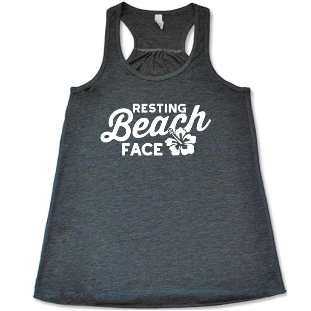 Grey colored flowy tank with a flower graphic on it that says "Resting Beach Face"