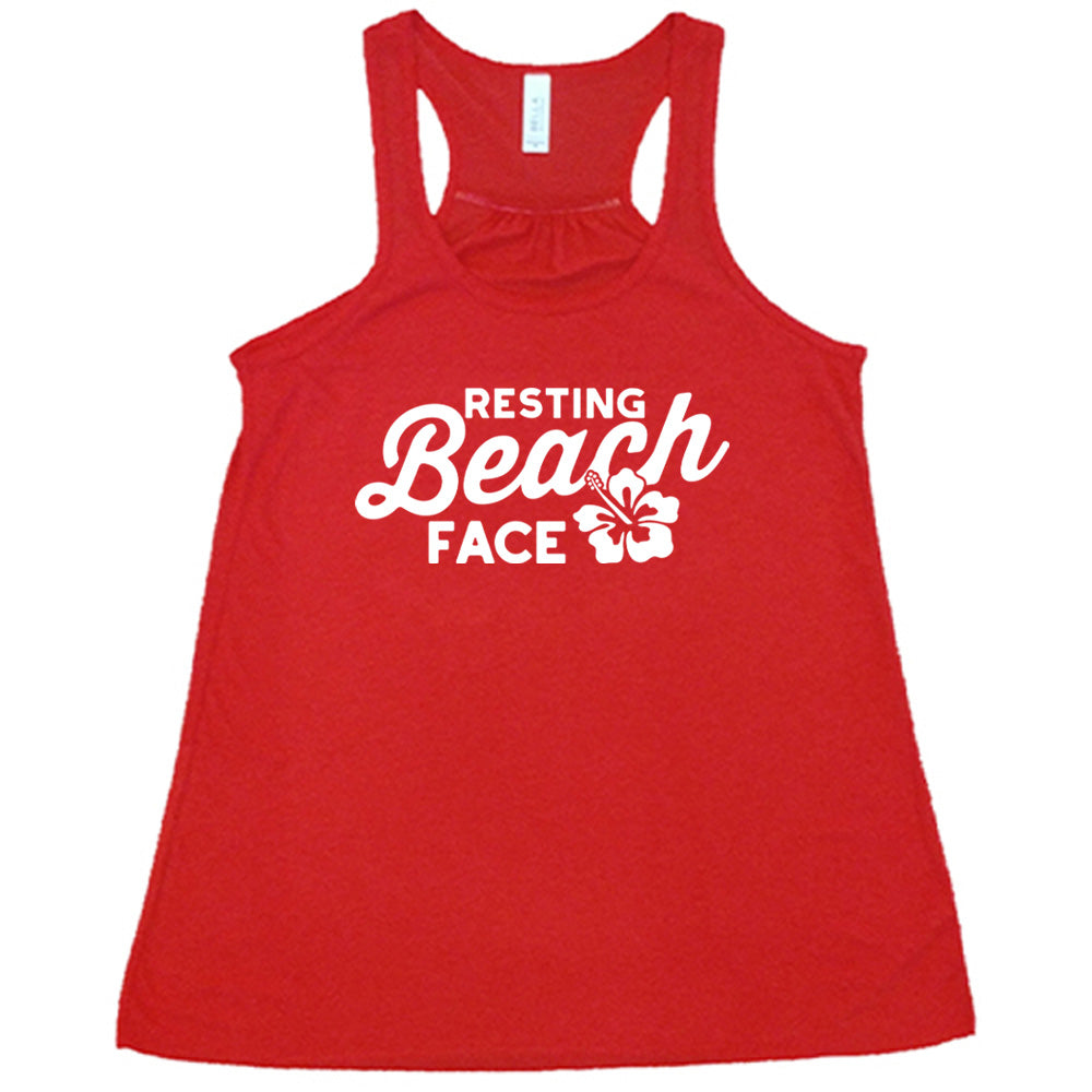 Red colored flowy tank with a flower graphic on it that says "Resting Beach Face"