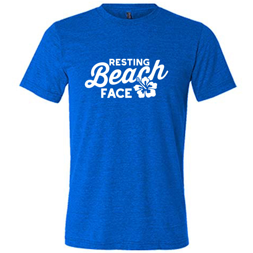 Blue colored shirt with a flower graphic on it that says "Resting Beach Face"