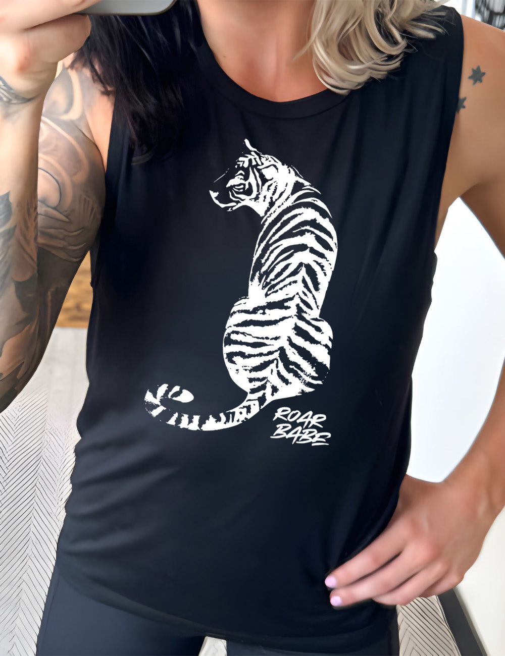 black muscle tank with the graphic of a tiger, from the back, sitting, looking to one side, with the words "roar babe" in small font underneath