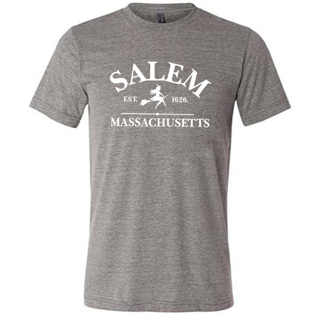 Grey colored shirt with witch on a broom graphic on it that says "Salem EST. 1626 Massachusetts"