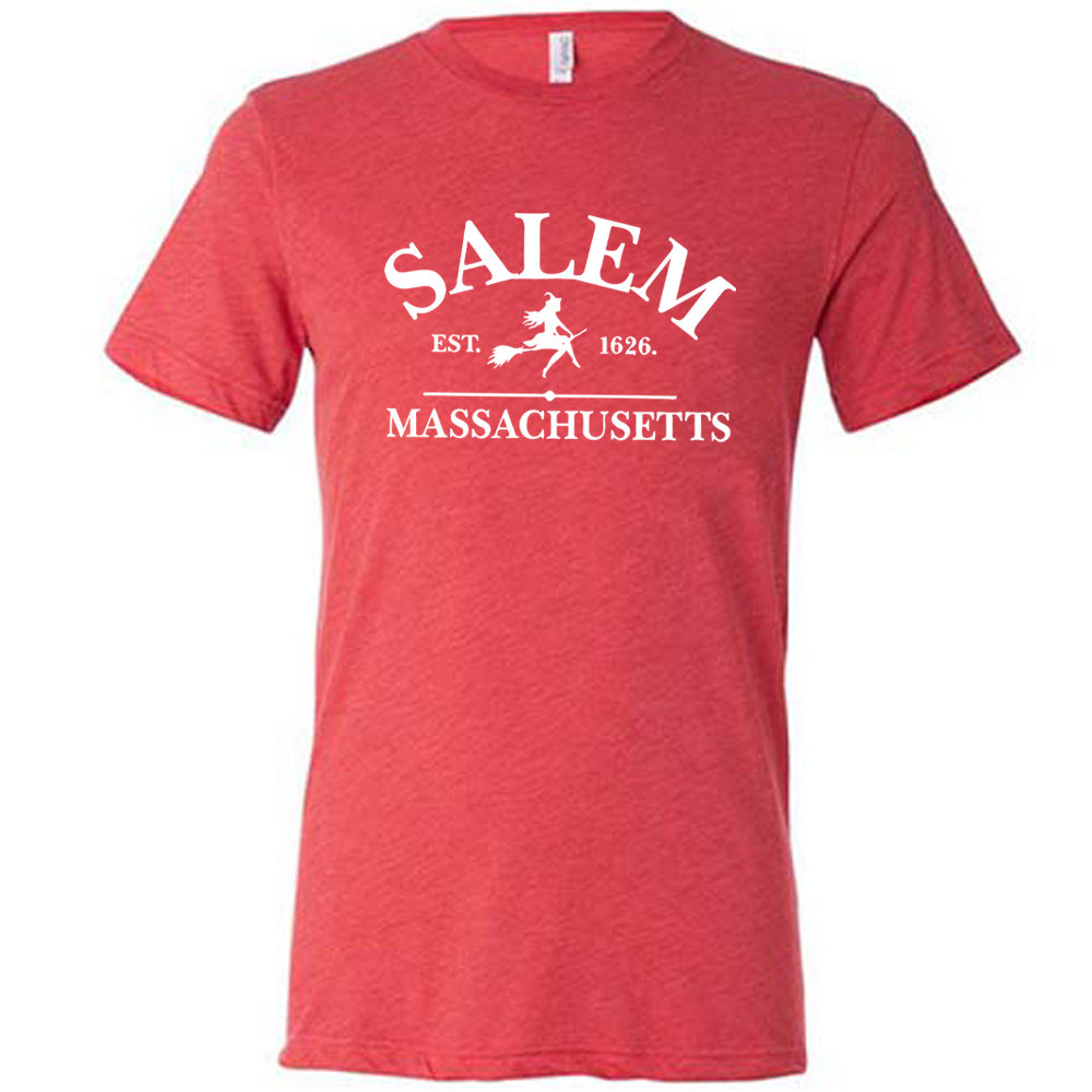 Red colored shirt with witch on a broom graphic on it that says "Salem EST. 1626 Massachusetts"