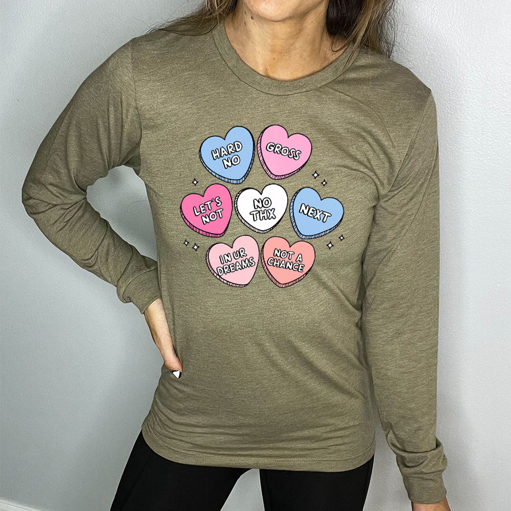 heather olive long sleeve shirt with the graphics of colorful cartoon valentine's heart candies, each saying different things on them: "hard no", "gross", "let's not", "no thx", "next", "in ur dreams", and "not a chance"