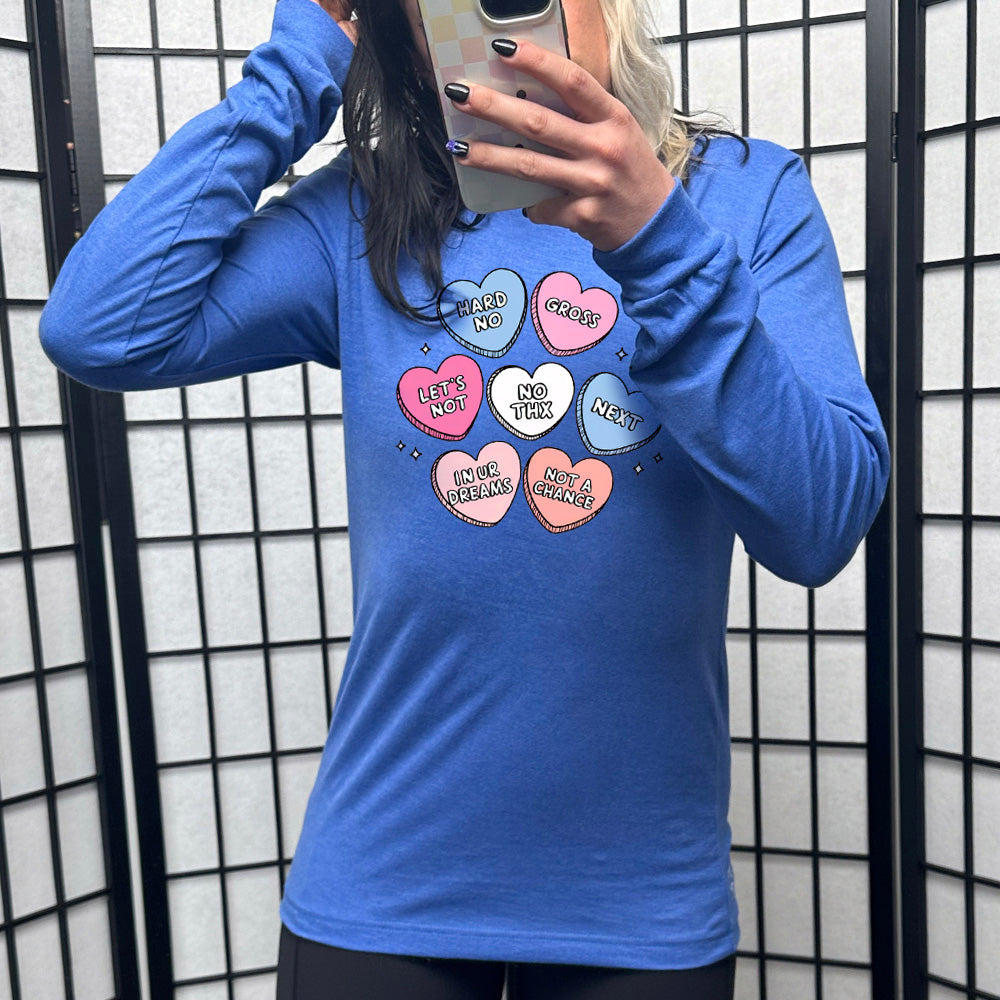 heather true royal long sleeve shirt with the graphics of colorful cartoon valentine's heart candies, each saying different things on them: "hard no", "gross", "let's not", "no thx", "next", "in ur dreams", and "not a chance"