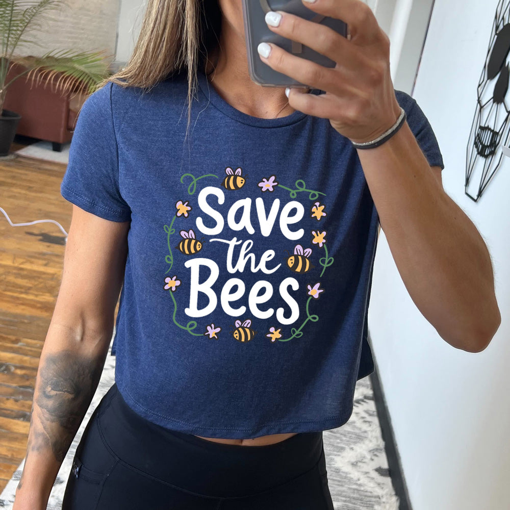Navy colored cropped tee with a bees and flowers graphic on it that says "Save The Bees"
