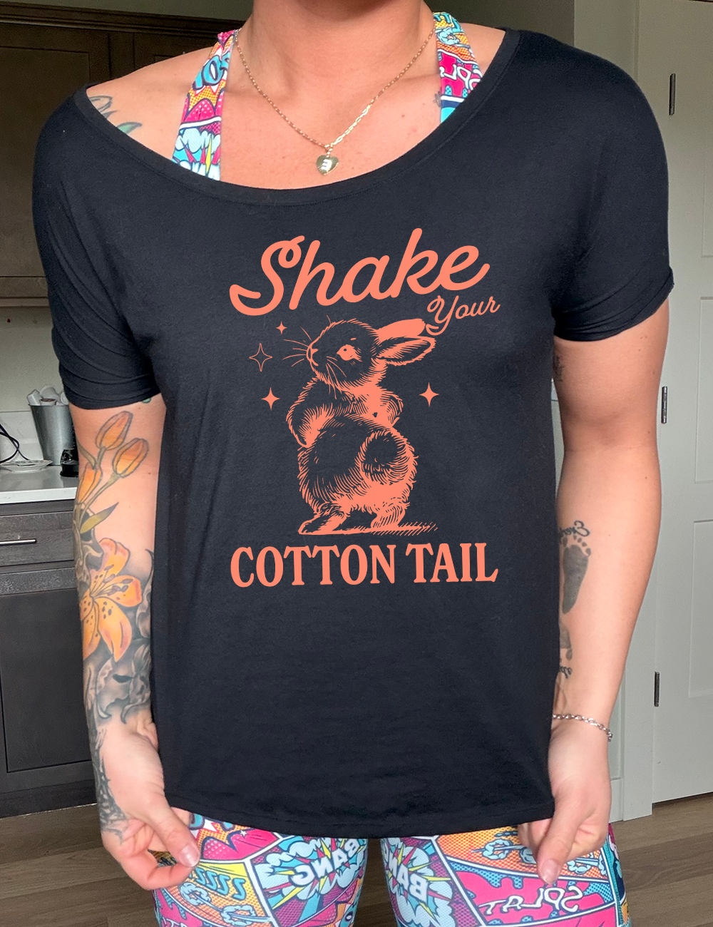 black slouchy tee with the words "shake your cotton tail" on it, with the large graphic of a rabbit, mid-shake of its behind, looking over its shoulder