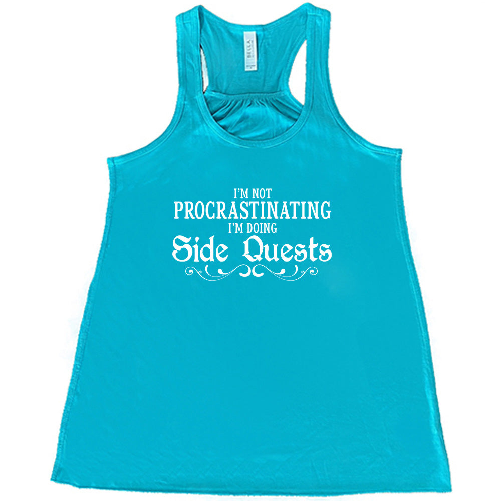 teal shirt with the text "I'm Not Procrastinating I'm Doing Side Quests" on it