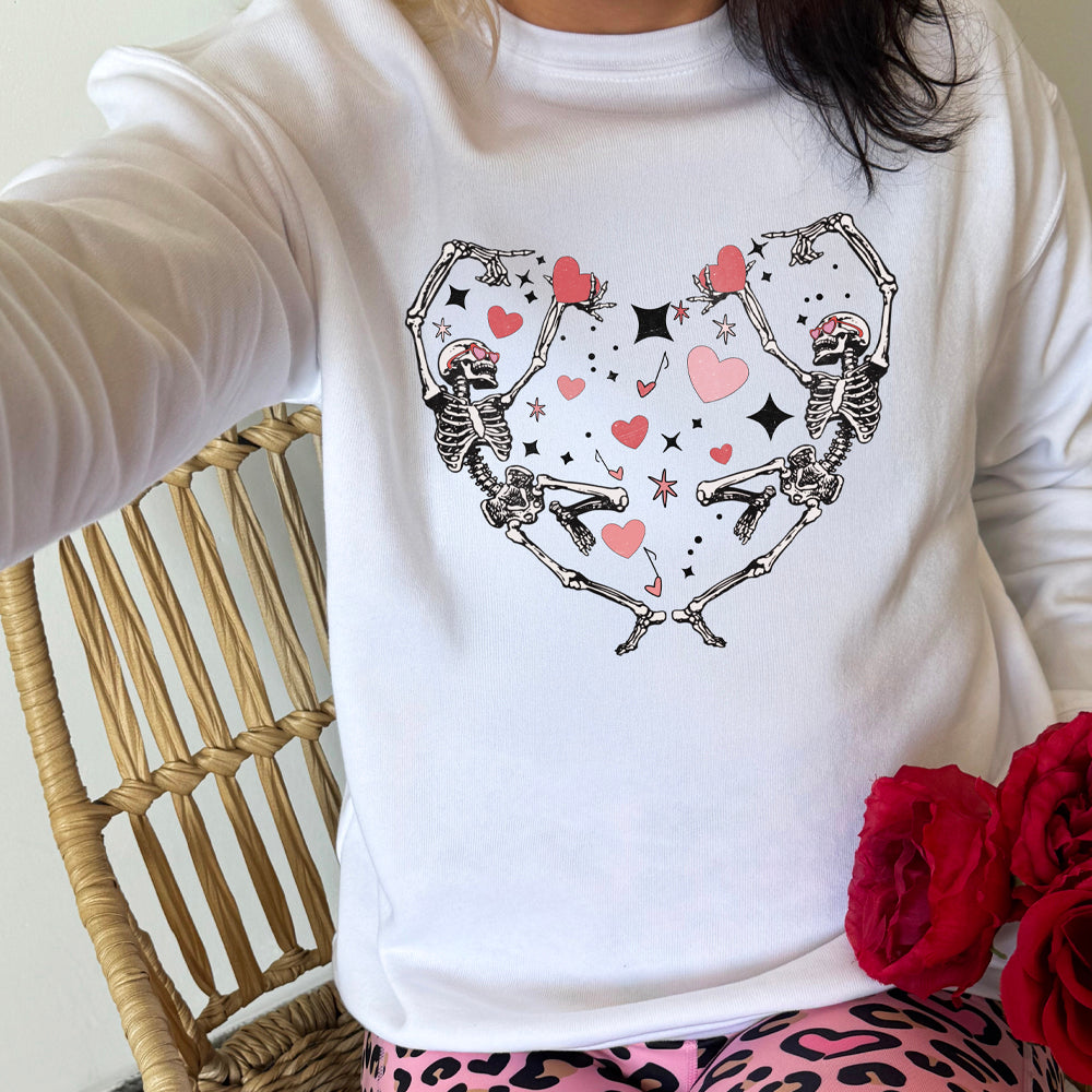 white crewneck with a skeleton heart graphic on it