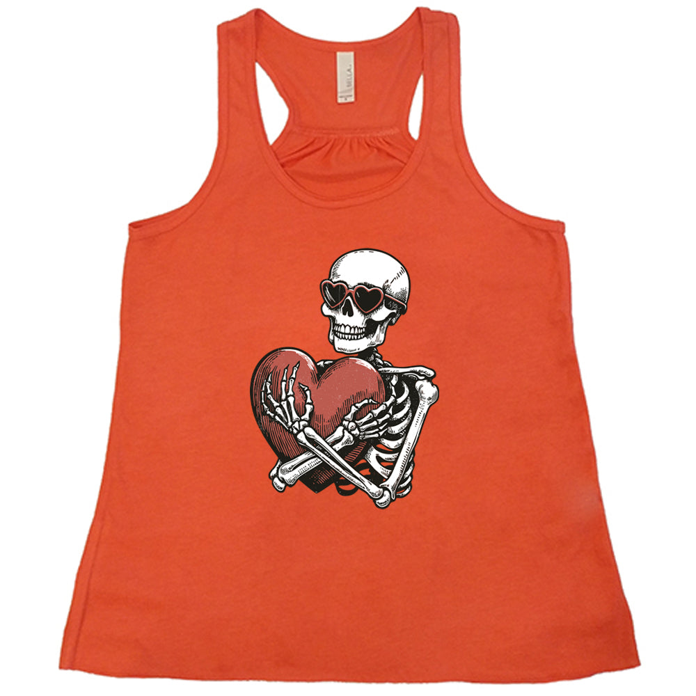 coral shirt with a skeleton hugging a heart graphic on it